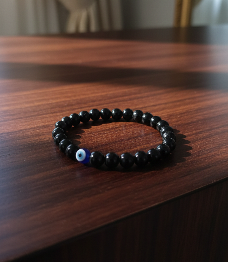 BLACK BEAD BRACELET WITH BLUE EVIL EYE